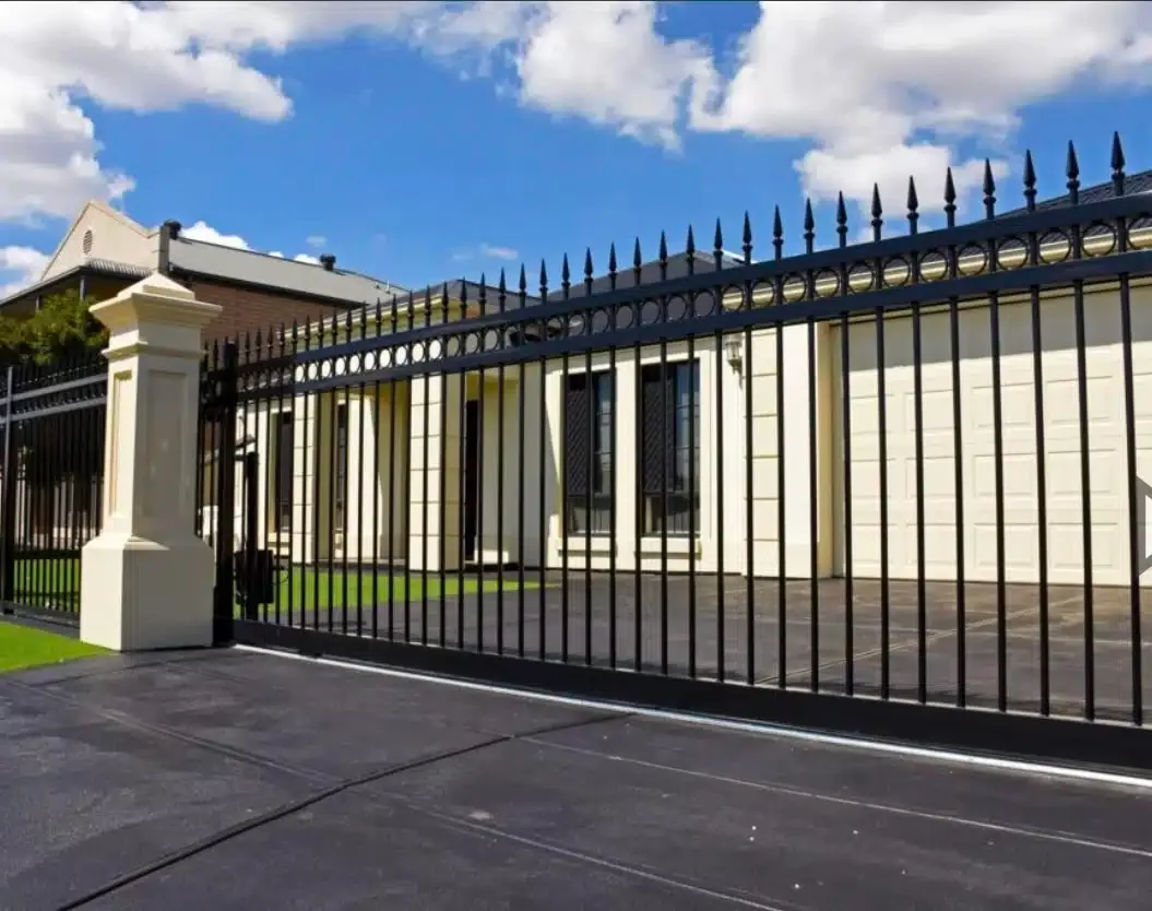 Black palisade automatic sliding gate across a home driveway